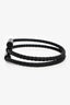 Bracelet jonc Hermès en cuir tressé noir et métal en forme de H « Tournis Tresse »