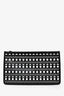 Pochette MM Alaïa en cuir perforé noir et blanc, avec fermeture zippée